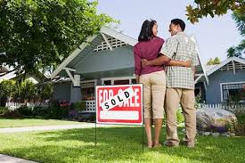 couple standing in front of new home